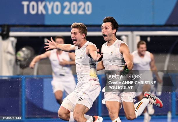 Players of Belgium celebrate after winning the men's gold medal match of the Tokyo 2020 Olympic Games field hockey competition by defeating Australia...