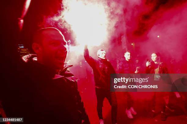 Flare is lit during an anti-lockdown protests in Melbourne on August 5 as authorities announced a sixth lockdown for the city in efforts to bring the...