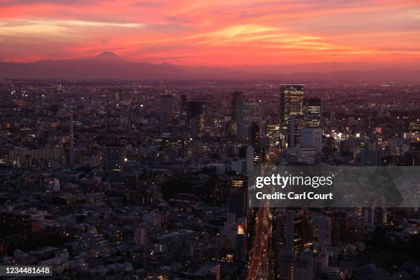 Mount Fuji looms in the distance as the sun sets over Tokyo on day 13 of the Tokyo Olympics on August 5, 2021 in Tokyo, Japan. With the Olympic Games...