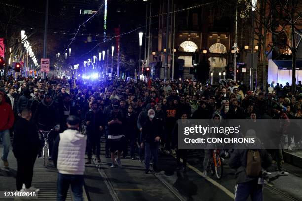 Anti-lockdown protesters march in Melbourne on August 5 as authorities announced a sixth lockdown for the city in efforts to bring the Delta outbreak...