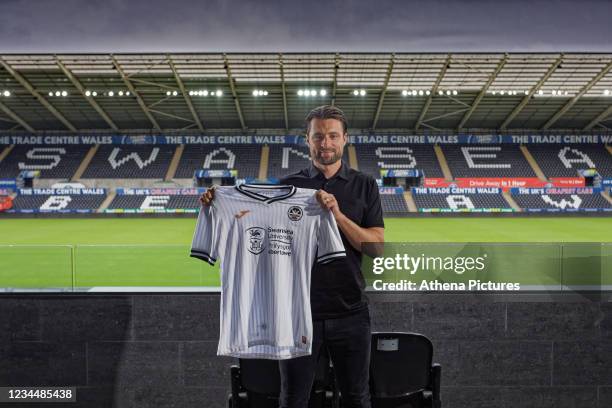 Newly appointed Manager Russell Martin poses for a picture while holding the home shirt after the Swansea City Press Conference at the Liberty...