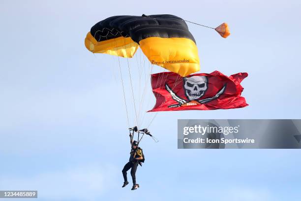 Member of the United States Special Operations Command Para-Commandos flies in with the Buccaneers flag before the start of the Tampa Bay Buccaneers...
