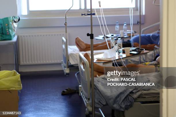 Patients lay on their bed in a unit dedicated to patients infected with Covid-19 at the hospital of Bastia on the French Mediterranean island of...