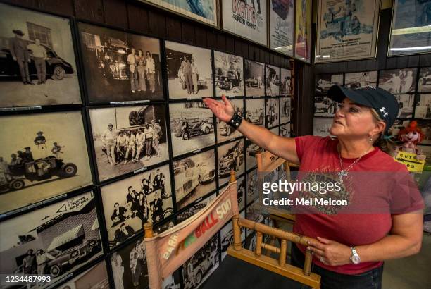 Joji Barris-Pastor, daughter of the late custom car designer George Barris, shows photographs on display of celebrities that have visited Barris...