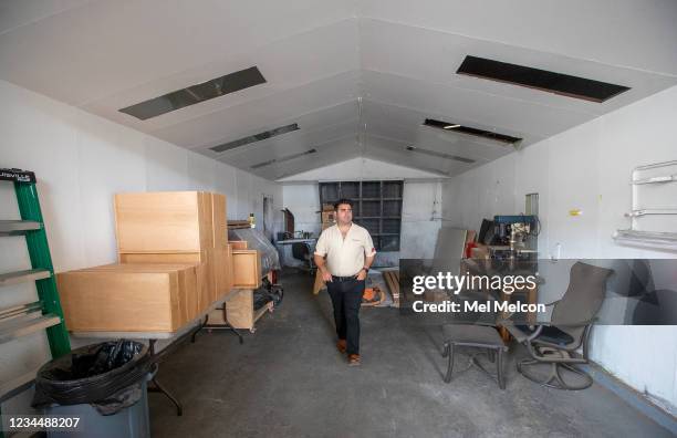 Jared Barris, grandson of the late custom car designer George Barris, walks inside the custom paint booth where iconic cars such as the Batmobile,...