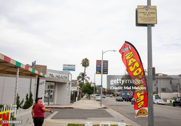 Joji Barris-Pastor, daughter of the late custom car designer George Barris, looks at a sign honoring her father on display outside the front entrance...