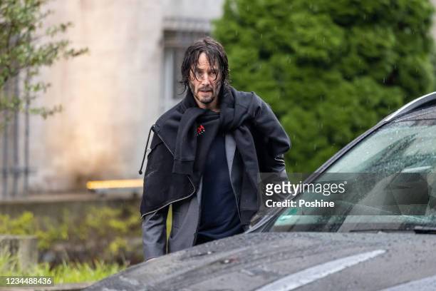 Keanu Reeves is seen leaving his hotel to go to the set of "John Wick: Chapter 4" on August 5, 2021 in Berlin, Germany.