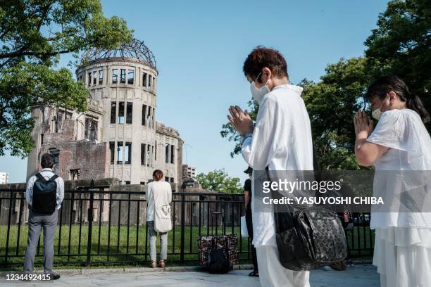 People offer prayers by the Atomic Bomb Dome, formerly the Hiroshima Prefectural Industrial Promotion Hall, shortly after 8:15am marking the time of...