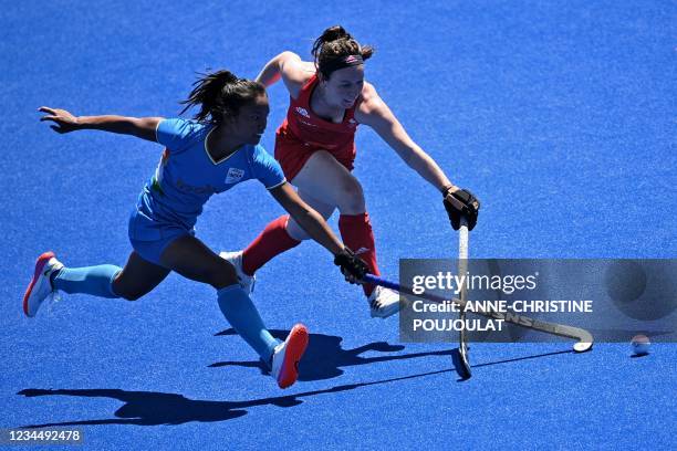 India's Lalremsiami and Britain's Laura Unsworth vie for the ball during the women's bronze medal match of the Tokyo 2020 Olympic Games field hockey...