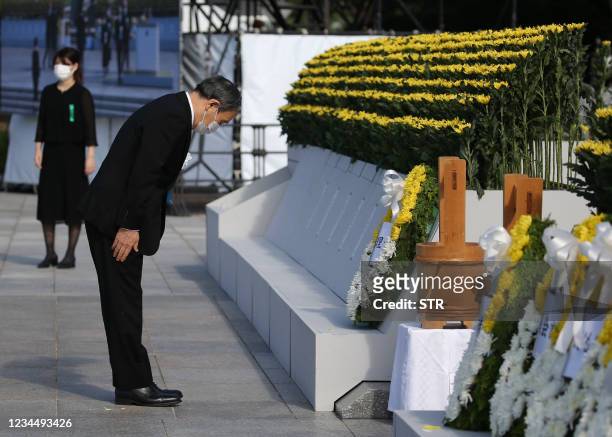 Japan's Prime Minister Yoshihide Suga pays his respects during a ceremony to mark the 76th anniversary of the world's first atomic bomb attack at the...