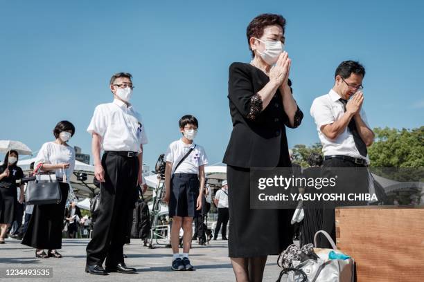 People pray at the Hiroshima Peace Memorial Park in Hiroshima on August 6 following the annual ceremony to remember the victims on the 76th...