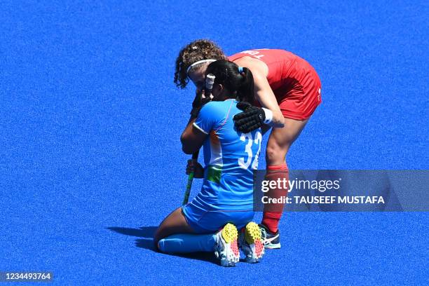 India's Neha Neha is comforted by Britain's Susannah Townsend after losing the women's bronze medal match of the Tokyo 2020 Olympic Games field...