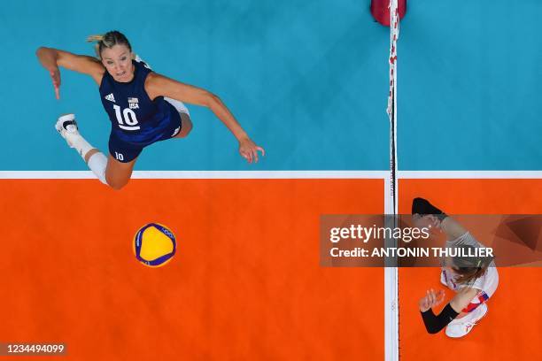 S Jordan Larson spikes the ball in the women's semi-final volleyball match between USA and Serbia during the Tokyo 2020 Olympic Games at Ariake Arena...