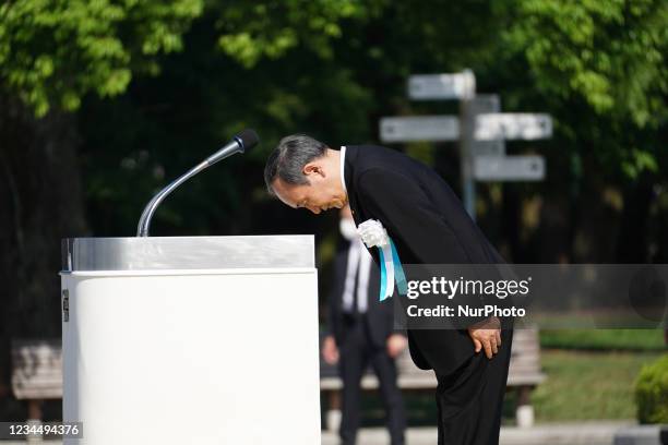 Japan's Prime Minister Yoshihide Suga bows during a commemoration in Peace Memorial Park, as Hiroshima marks the 76th anniversary of the atomic...