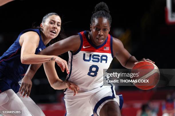 S Chelsea Gray dribbles the ball past Serbia's Sasa Cado in the women's semi-final basketball match between USA and Serbia during the Tokyo 2020...