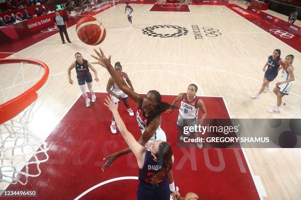 S Sylvia Fowles goes to the basket past Serbia's Angela Dugalic in the women's semi-final basketball match between USA and Serbia during the Tokyo...