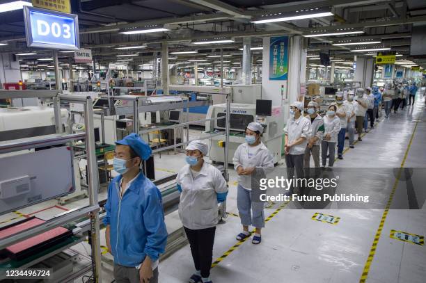 Workers in the Foxconn factory line up for the all-inclusive Covid-19 test in Wuhan in central China&#039;s Hubei province Thursday, Aug. 05, 2021....