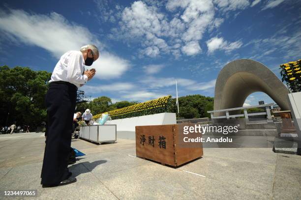 People pray in front of the Cenotaph for the Bomb Victims after the Hiroshima Peace Memorial Ceremony at the Hiroshima Peace Memorial Park on the day...