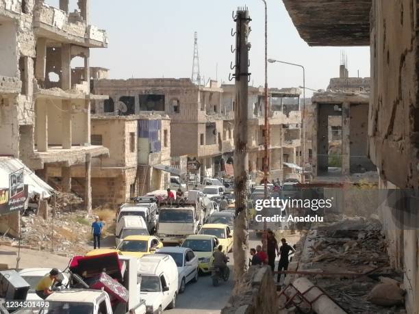 Syrians are seen with their belongings during their evacuation process in Daraa, Syria on August 05, 2021. 80 percent of 50,000 civilians leave their...