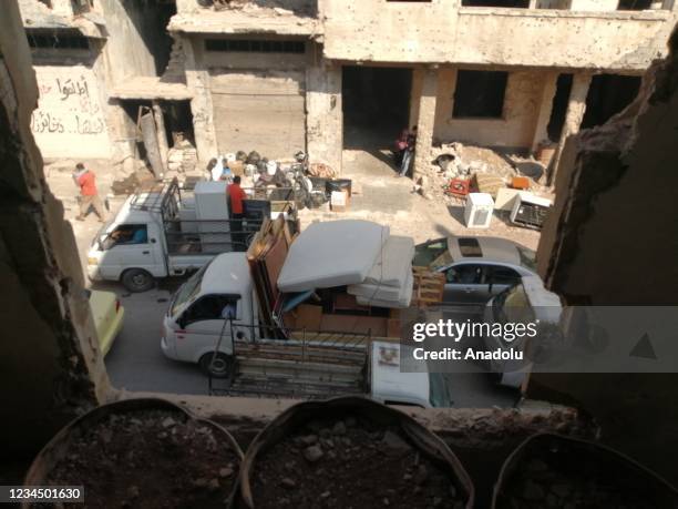 Syrians are seen with their belongings during their evacuation process in Daraa, Syria on August 05, 2021. 80 percent of 50,000 civilians leave their...