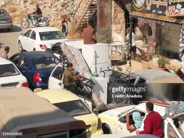 Syrians are seen with their belongings during their evacuation process in Daraa, Syria on August 05, 2021. 80 percent of 50,000 civilians leave their...