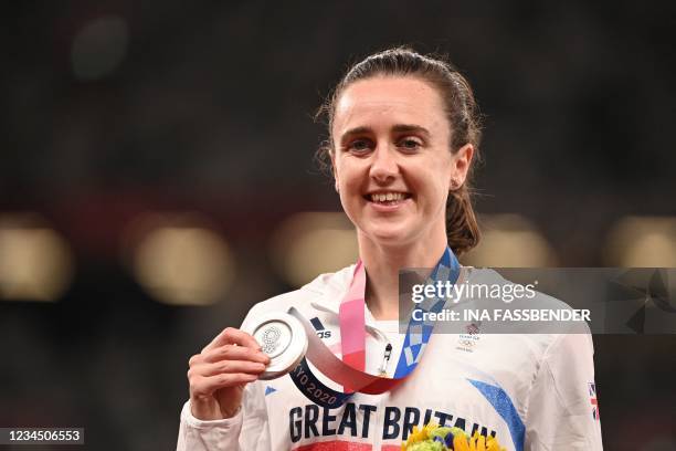 Silver medallist Britain's Laura Muir celebrates on the podium during the medal ceremony for the women's 1500m final during the Tokyo 2020 Olympic...