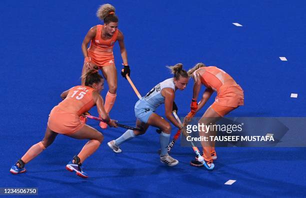 Argentina's Victoria Sauze Valdez dribbles the ball past players of Netherlands during the women's gold medal match of the Tokyo 2020 Olympic Games...