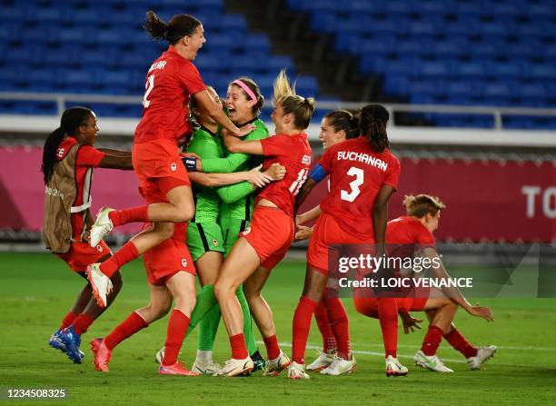 Canada's players celebrate after midfielder Julia Grosso scored the winning penalty during the penalty shoot-out of the Tokyo 2020 Olympic Games...