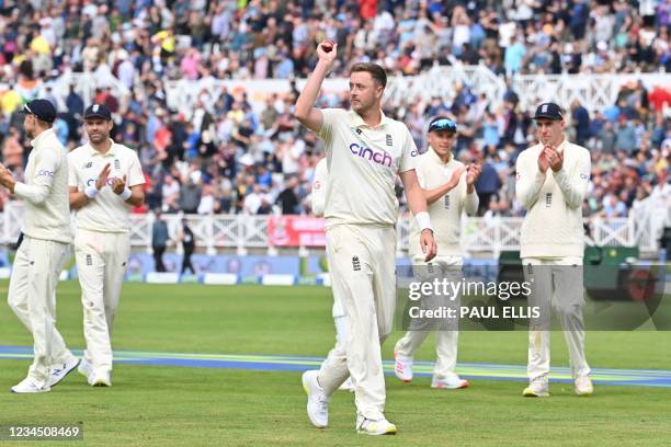 England's Ollie Robinson acknowledges the crowd after taking five wickets at the end of the first innings on the third day of the first cricket Test...