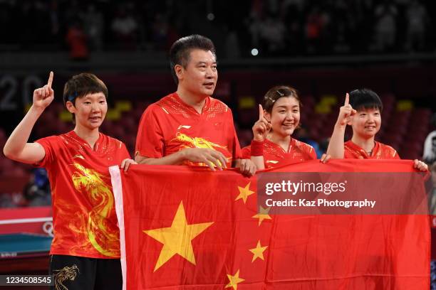 Yingsha Sun, Meng Chen and Manyu Wang of Pepople's Republic of China show Number 1 with national flag after Table Tennis Women's Team Final on day...