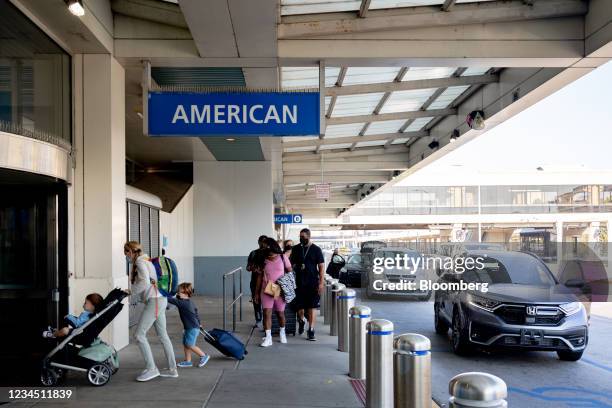 Travelers arrive at Philadelphia International Airport in Philadelphia, Pennsylvania, U.S., on Friday, Aug. 6, 2021. Citing a surge in unruly...