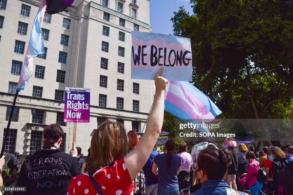 A protester holds a 'We Belong' placard during the trans...