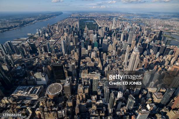 An aerial view shows Madison Square Garden , and empire State Building and the city skyline of midtown Manhattan and New York city on August 5, 2021.