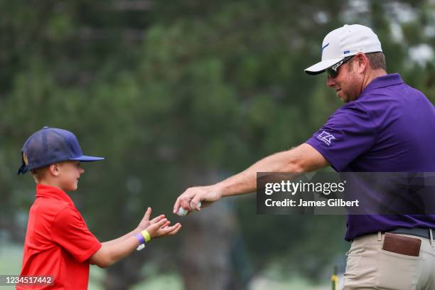 Dan McCarthy hands a ball to a young fan on the 9th green during the second round of the Utah Championship presented by Zions Bank at Oakridge...