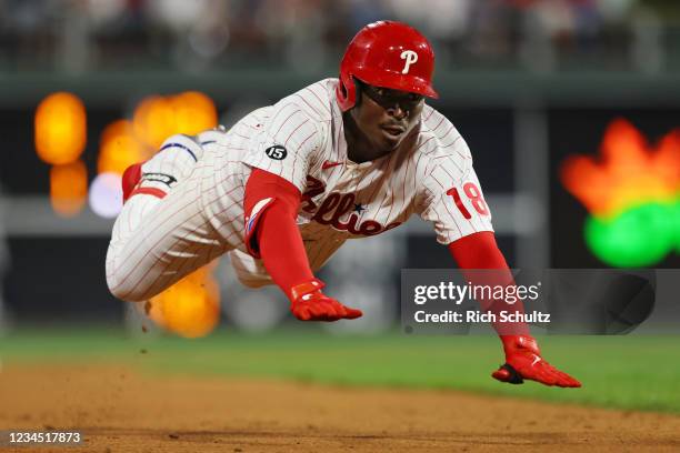 Didi Gregorius of the Philadelphia Phillies dives into third base with a triple during the fourth inning of a game against the New York Mets at...