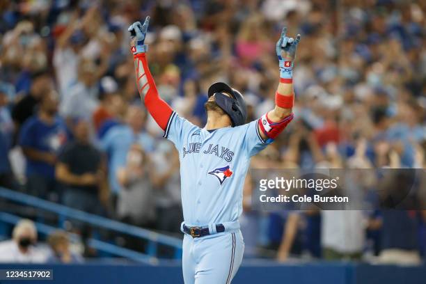 Lourdes Gurriel Jr. #13 of the Toronto Blue Jays celebrates a home run at the plate in the fifth inning of their MLB game against the Boston Red Sox...