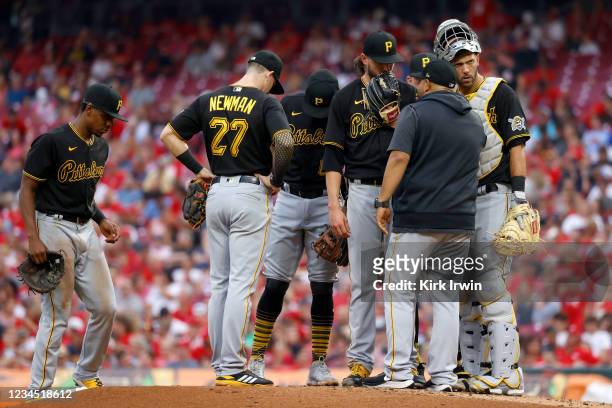 Pitching coach Oscar Marin of the Pittsburgh Pirates talks with JT Brubaker after giving up a three-run home run to Tucker Barnhart of the Cincinnati...