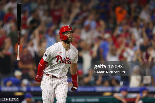 Bryce Harper of the Philadelphia Phillies flips his bat after hitting a two-run home run against the New York Mets during the eighth inning of a game...