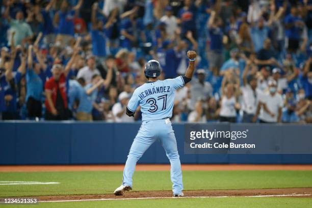Teoscar Hernandez of the Toronto Blue Jays celebrates along the third base line as he runs home on a Lourdes Gurriel Jr. #13 home run in the fifth...