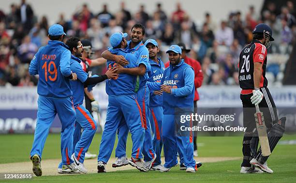 Praveen Kumar of India celebrates with his teammates after dismissing England captain Alastair Cook during the NatWest One Day International between...