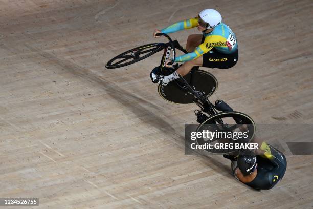 Kazakhstan's Sergey Ponomaryov crashes with Malaysia's Muhammad Shah Firdaus Sahrom in the men's track cycling keirin first round heats during the...