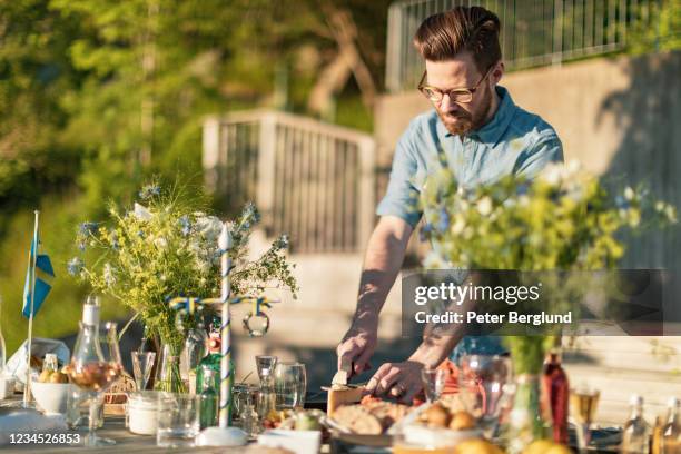 ein mann schneidet eine scheibe käse - maypole stock-fotos und bilder