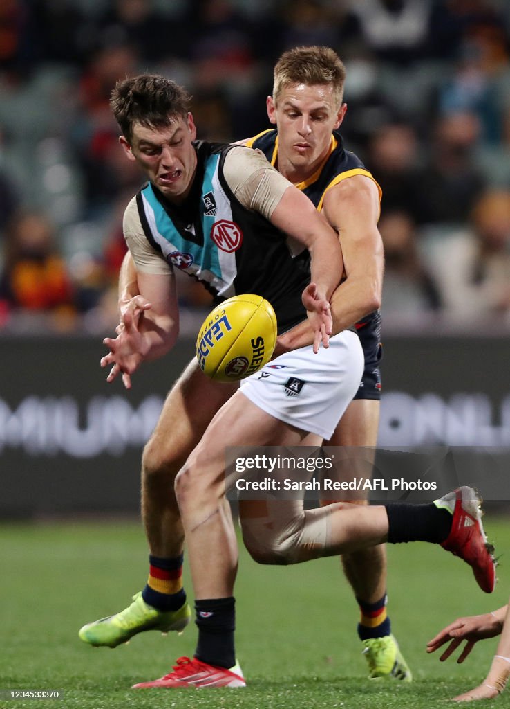 David Raffen Adelaide Zak Butters of the Power and David Mackay of the Crows during the ...