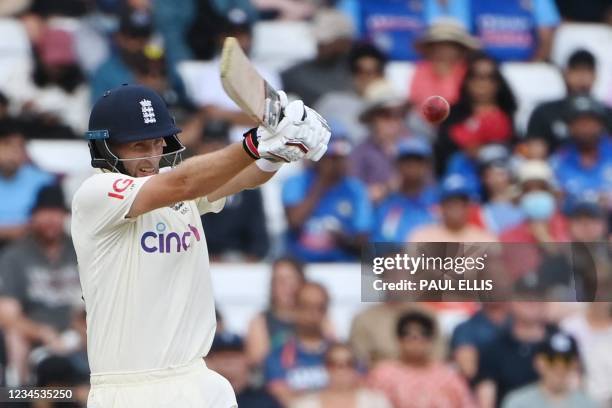 England's captain Joe Root plays a shot on the fourth day of the first cricket Test match of the India Tour of England 2021 between England and India...