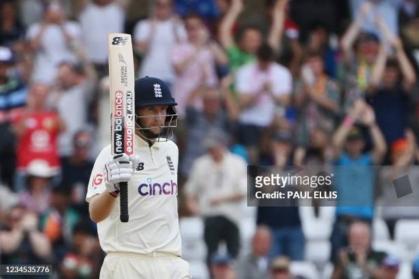 England's captain Joe Root celebrates his half-century on the fourth day of the first cricket Test match of the India Tour of England 2021 between...
