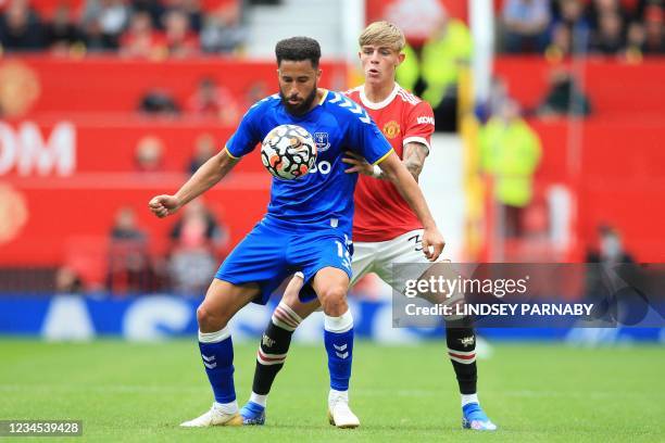 Everton's Turkish striker Cenk Tosun vies with Manchester United's English defender Brandon Williams during the pre-season friendly football match...
