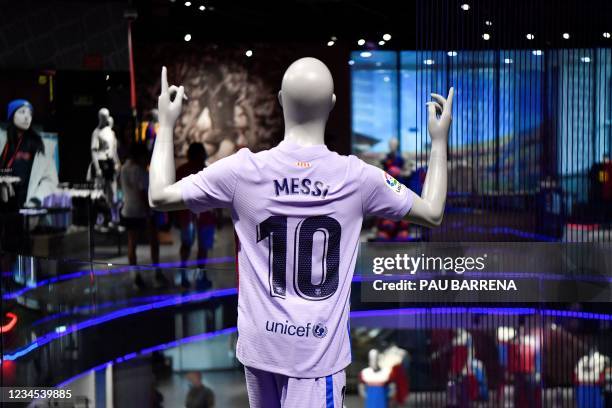 Football jersey bearing the name of Barcelona's Argentinian forward Lionel Messi is displayed on a mannequin at the official store of the Camp Nou...