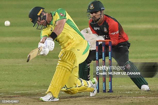 Australia's Dan Christian plays a shot and Bangladesh's Quazi Nurul Sohan looks on during the fourth Twenty20 international cricket match between...