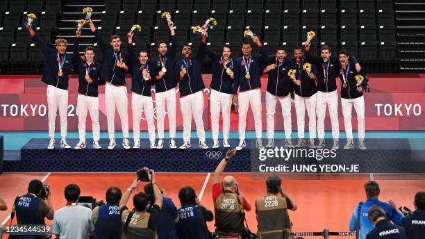 Gold medallists France's players stand on the podium during the men's volleyball victory ceremony during the Tokyo 2020 Olympic Games at Ariake Arena...