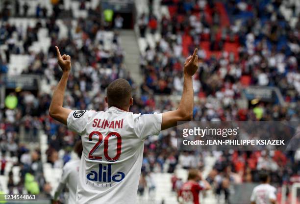Lyon's Algerian forward Islam Slimani celebrates after scoring his team's first goal during the French L1 football match between Lyon and Brest , at...